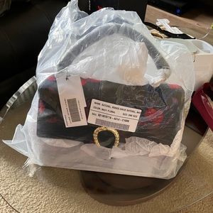 Black and blue bag with red flowers